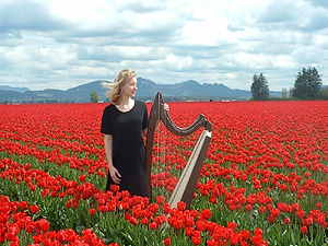 Amy with harp in tulip field